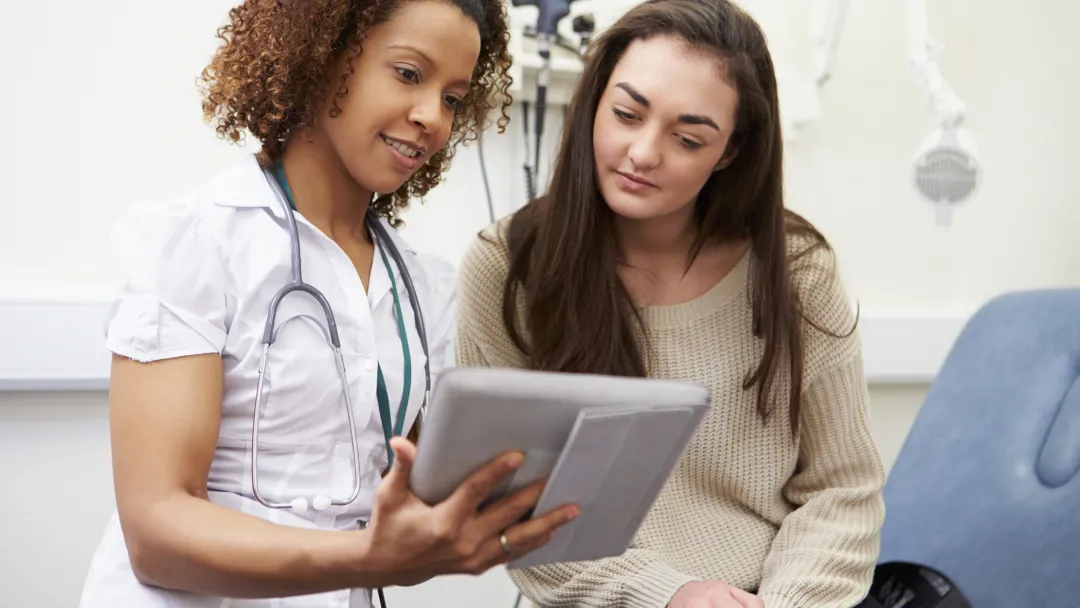 A young woman consults with her physician.