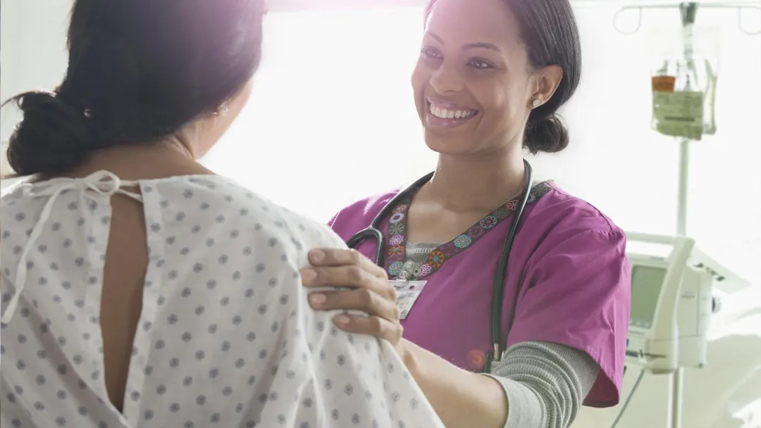 A Nurse Speaks to a Patient with Happy News