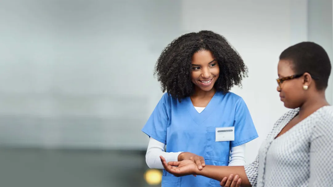Nurse checking a patient's pulse