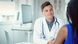 Doctor sitting at a table with a patient