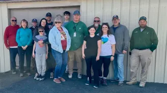 Volunteers stand outside church