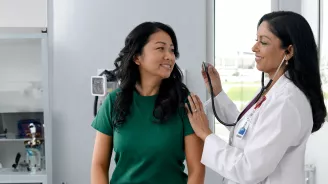 Primary Care Plus Provider with patient in clinic