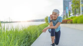 Older female runner taking a break