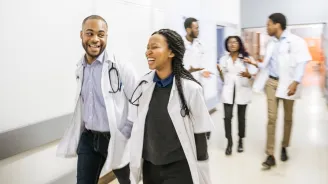Medical students walking down a hallway.