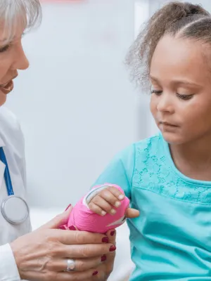 A Doctor Check's a Little Girl's New Cast