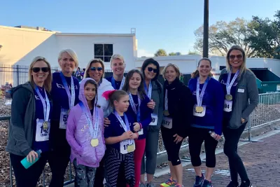 runners crossing finish line at AdventHealth Lady Track Shack 5k