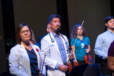 Grace Lai and Dr. Vincent Hsu with the AdventHealth employee orchestra.