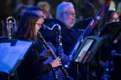 Amelia Lane performs with the AdventHealth employee orchestra at Disney Springs.