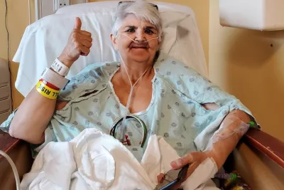 Patient Carol Dunn giving a thumbs up after her surgery.