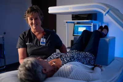 Senior female patient receiving a bone density scan.