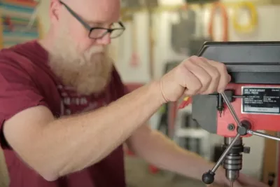 Mat Germann operating a drill press.