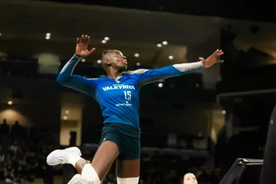 Orlando Valkyries player jumps into the air to hit a ball