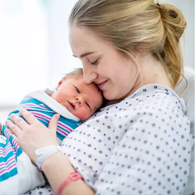 A mom holding her newborn.