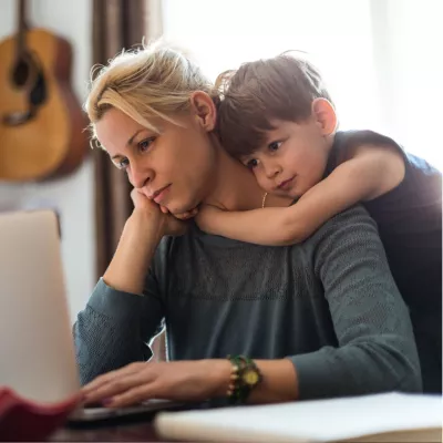 A Son Hugs His Mother While She Tries to Find Help on the Internet