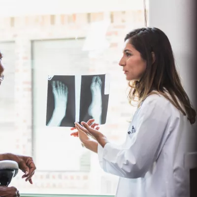 A Provider Goes Over a Foot X-Ray with Her Patient