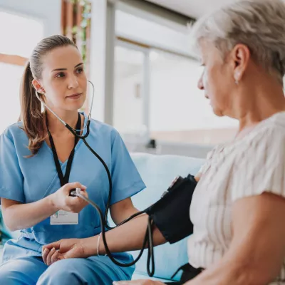 A Nurse Takes a Patient's Blood Pressure