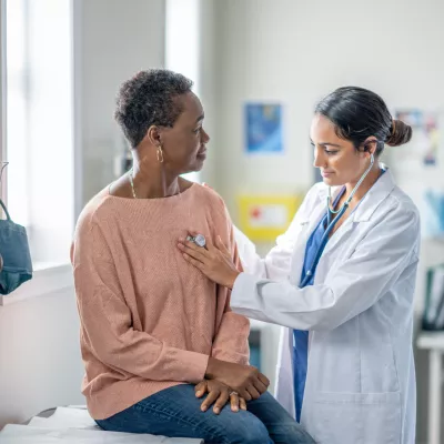 A Doctor Check's Her Patient Breathing with a Stethoscope 