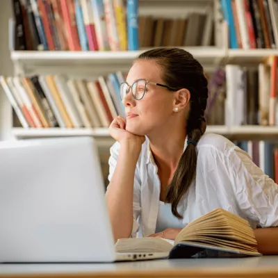 A Teen Stares Out the Window While in the Middle of Her Homework