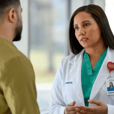 A Close Up of a Physician Speaking with a Patient 