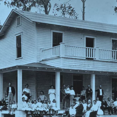 Men and women standing outside of a sanitarium