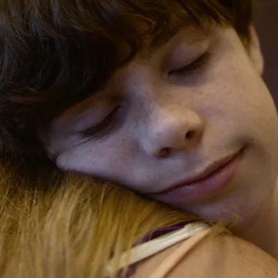 Cory and her son in an embrace.