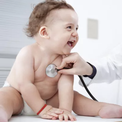 Happy baby visiting the pediatrician 