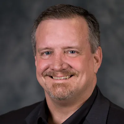 A Headshot of Author Roy Reid