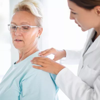 Woman Discussing Her Pain with Doctor