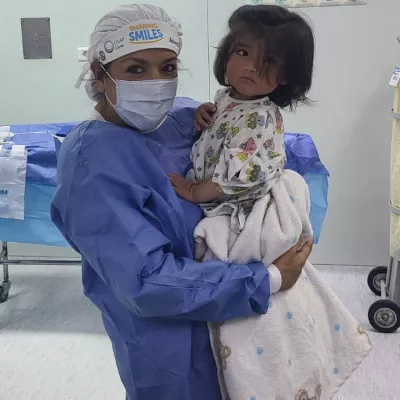 Maria Rodammer holding a child