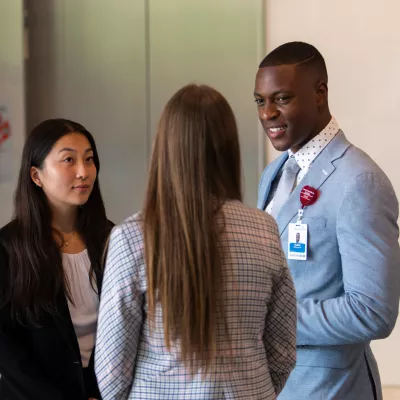 AdventHealth Leadership interns talking in AdventHealth Headquarters lobby.