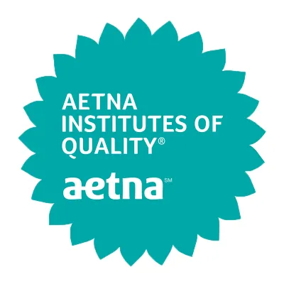 Aetna's circular turquoise badge with sunflower frills around it