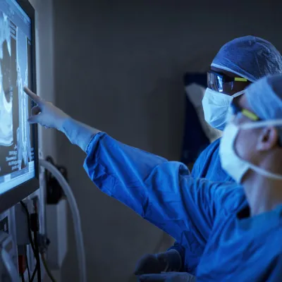 AHMD Masked Physicians looking at X-Rays