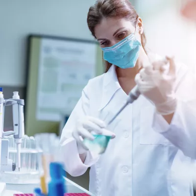  Masked Physician in lab working 