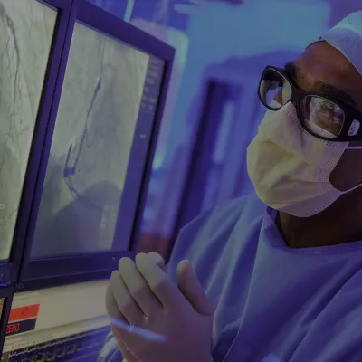 Surgeon reviewing scans on a computer screen