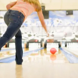 A woman bowling.