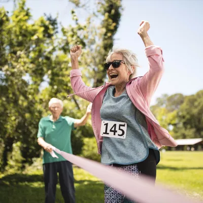Elderly woman finishes breast cancer fundraising event