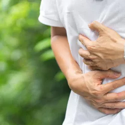 Man holding his stomach in pain