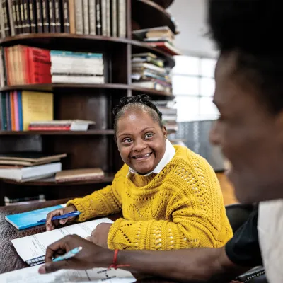 Woman with Down Syndrome working at a desk