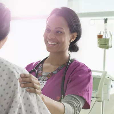 A Nurse Speaks to a Patient with Happy News