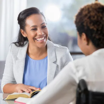 A CPE Pastor Reads the Bible to a Patient