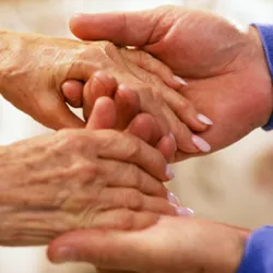 Two people hold hands.