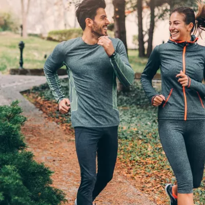 Two friends jogging in a park