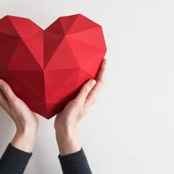 hands holding a heart-shaped object