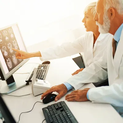 Two doctors look at an MRI scan