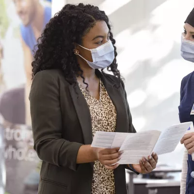 A woman checking in for a visit at AdventHealth. 