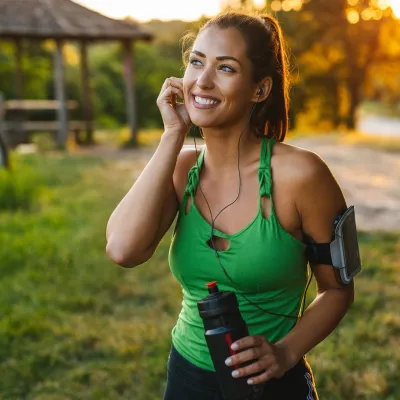 A woman preparing to go on a run outdoors.