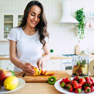 A young woman prepping food at home.