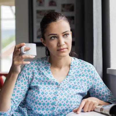 A woman sitting by the window.
