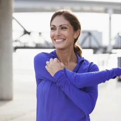 A woman stretching her shoulder.