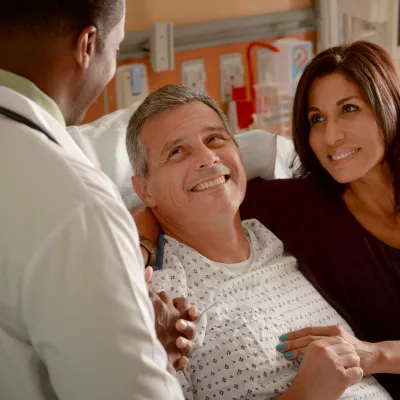 Supportive AdventHealth doctor with patient and caregiver.